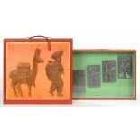 TWO DISPLAY CASES OF EXAMPLES OF RELIEF SCULPTURE, IN WOOD AND RESIN, 43 X 51CM EXCLUDING HANDLE,