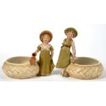 A PAIR OF ROYAL DUX FIGURES OF A BOY AND GIRL BESIDE A LARGE WOVEN BASKET, 12.5CM H, MARK