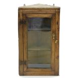 AN OAK CORNER CUPBOARD WITH IRON BUTTERFLY HINGES, 78CM H X 45CM W