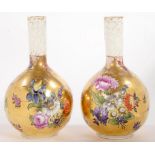A PAIR OF GERMAN GILT GROUND BOTTLE SHAPED VASES, PAINTED WITH FLOWERS, THE NECK WITH CAILLOUTE,