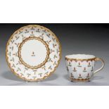 A PINXTON FLUTED CUP AND SAUCER, 1796-1813, with a formal rose hip pattern in purple, saucer 13cm