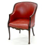 A CARVED MAHOGANY LIBRARY CHAIR COVERED IN RED LEATHER, EARLY 20TH C