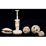 TWO CHINESE IVORY PUZZLE BALLS, A STAND, CLAMSHELL CARVING AND ANOTHER ITEM, LARGER BALL AND STAND