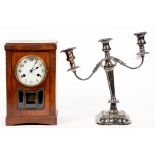 A MAHOGANY MANTEL CLOCK WITH ENAMEL DIAL AND GLAZED FRONT, 33CM H AND AN EPNS CANDELABRUM