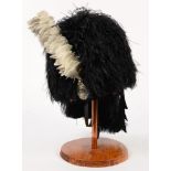 A SCOTTISH FEATHER BONNET AND PLUME ARGYLE AND SUTHERLAND HIGHLANDERS BUSBY HELMET, METAL BADGE ON