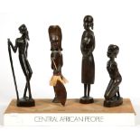TRIBAL AND FOLK ART. FOUR CENTRAL AFRICAN CARVED WOOD FIGURES ON FABRIC COVERED AND PAINTED BASE,