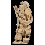 A JAPANESE IVORY OKIMONO OF AN ITINERANT ENTERTAINER AND CHILDREN, 15CM H, MEIJI PERIOD