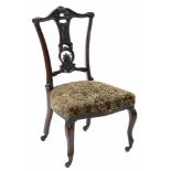 AN EDWARDIAN CARVED MAHOGANY SALON CHAIR ON POTTERY CASTORS