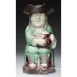 A STAFFORDSHIRE CREAMWARE TOBY JUG, C1780-1800 decorated in bright green and manganese glazes, 26.