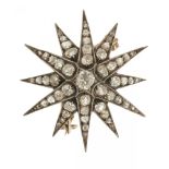 A VICTORIAN DIAMOND STAR BROOCH-PENDANT the central old mine cut diamond surrounded by old cut and