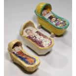 THREE STAFFORDSHIRE MOULDED EARTHENWARE MODELS OF CRADLES, C1810-20 each sleeping child therein