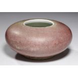 A CHINESE PEACH BLOOM GLAZED BRUSH WASHER, QING DYNASTY of compressed form and incised with two