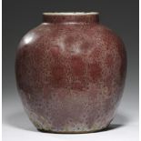 A CHINESE FLAMBE GLAZED JAR, QING DYNASTY covered in a mottled uneven dull red glaze of orange