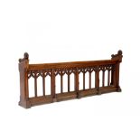 A VICTORIAN GOTHIC OAK CHOIR DESK, C1856-1878 with open arcaded front and foliate carved ends,