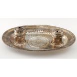 A GADROONED AND FLUTED OVAL SILVER INKSTAND with let in royal arms medallic centre flanked by