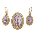 A GOLD BROOCH SET WITH AN ENAMEL MINIATURE OF FAIRIES and a pair of similar earrings, brooch 3 x 2.2