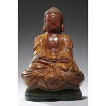 A CHINESE SANCAI GLAZED TILEWORKS FIGURE OF BUDDHA, MING DYNASTY, 16TH/EARLY 17TH C with swastika on