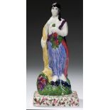 A SCOTTISH EARTHENWARE FIGURE OF SPRING FROM A SET OF THE SEASONS, EARLY 19TH C brightly decorated