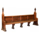 A VICTORIAN GOTHIC OAK BENCH, C1856-1878 with carved poppy-heads, 147cm h ; 51 x 290cm, painted