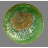 A CHINESE GREEN GLAZED DISH, MING DYNASTY well potted with rounded sides and groove beneath the rim,