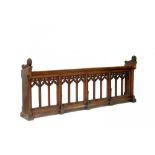 A VICTORIAN GOTHIC OAK CHOIR DESK, C1856-1878 with open arcaded front with foliate carved ends,