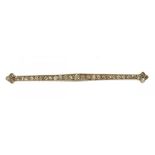 AN EDWARDIAN OLD CUT DIAMOND BAR BROOCH the diamonds approx 0.85 ct, millegrain set in platinum, 6.8