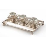 A GEORGE II SILVER INKSTAND with silver mounted faceted glass inkwell, quill holder and pounce pot