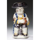 A STAFFORDSHIRE EARTHENWARE TOBY JUG OF 'RALPH WOOD' TYPE, C1825 the seated toper with a small