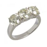 A THREE STONE DIAMOND RING the brilliant cut diamonds approx 2.68 ct, M/N colour, SI2 clarity, in