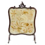 AN EDWARD VII CARVED MAHOGANY FIRESCREEN, C1905 the embroidered banner worked in silk with a