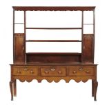 A GEORGE III OAK DRESSER, 18TH/EARLY 19TH C, with a rack with shaped doors to the spice cupboards,