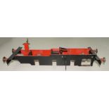 A BLACK AND RED PAINTED FERROUS METAL MODEL LOCOMOTIVE FRAME, 55CM L OVERALL