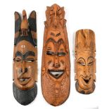 TRIBAL ART. THREE AFRICAN CARVED AND PAINTED HARDWOOD MASKS, 72 X 24CM AND SMALLER