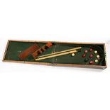 A VICTORIAN MAHOGANY FOLDING BAGATELLE SET