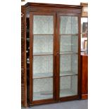 A VICTORIAN GLAZED MAHOGANY BOOKCASE ON BUN FEET, 188CM H; 106 X 41CM