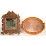 A CONTINENTAL CARVED WOOD MIRROR WITH BEVELLED PLATE, 36 X 29CM AND A TWO HANDLED TEA TRAY, 35CM W