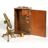 A VICTORIAN BRASS MICROSCOPE IN FITTED MAHOGANY CASE WITH TWO LENSES