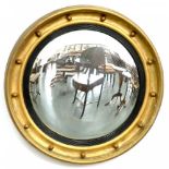 A REGENCY CIRCULAR GILTWOOD AND COMPOSITION MIRROR, THE CONVEX PLATE PROBABLY THE ORIGINAL, 62CM D