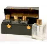 A SET OF FOUR CONTINENTAL FACETED GLASS COLOGNE BOTTLES, THE GILTMETAL SCREW CAP ENGRAVED WITH