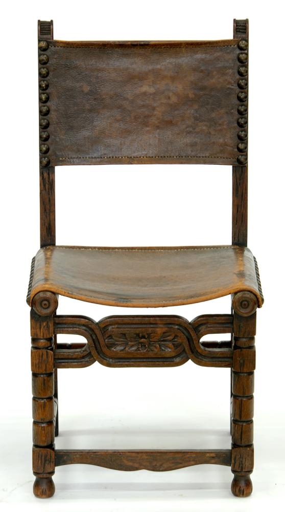 A SPANISH CARVED OAK CHAIR, WITH NAILED LEATHER BACK AND SEAT