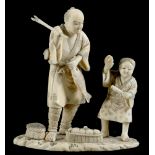 A JAPANESE IVORY OKIMONO OF A FISHERMAN AND HIS SON, 10.5CM H, SIGNED IN RED, MEIJI PERIOD