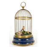 A BRASS AND PATINATED METAL CLOCKWORK SINGING BIRD-IN-A-CAGE AUTOMATON, 32CM H, 20TH C