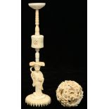 A CHINESE IVORY PUZZLE BALL CARVING AND A SMALLER JAPANESE MINIATURE IVORY FIGURE OF A WOMAN, ON