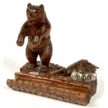 A SWISS NATURALISTIC CARVED LIMEWOOD 'BEGGING' BEAR INKSTAND WITH GLASS WELL, 13.5CM L, C1900