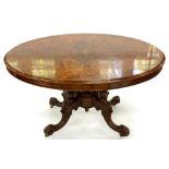 A VICTORIAN WALNUT LOO TABLE WITH QUARTER VENEERED TOP ON CARVED BASE, 75CM H; 100 X 135CM