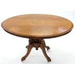 A VICTORIAN INLAID WALNUT LOO TABLE WITH QUARTER VENEERED TOP ON CARVED PEDESTAL AND FOUR