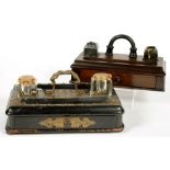 A VICTORIAN EBONISED INKSTAND WITH APPLIED STUDDED BRASS STRAPWORK AND A PAIR OF GLASS INKWELLS,