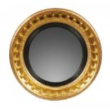 A GEORGE IV CIRCULAR GILTWOOD MIRROR, C1830, the convex plate in reeded ebonised slip and cavetto