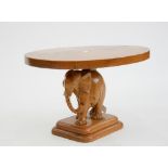 A SOUTH EAST ASIAN CARVED HARDWOOD ELEPHANT COFFEE TABLE, 43CM H; 73 X 58CM