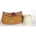 A LADY'S WOVEN CLUTCH BAG AND AN EARTHENWARE MILK JUG, 13CM H, EARLY 20TH C